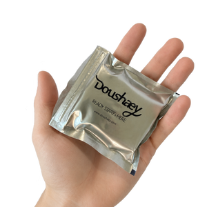 Sealed foil sachet containing a Doushaey disposable anal douche